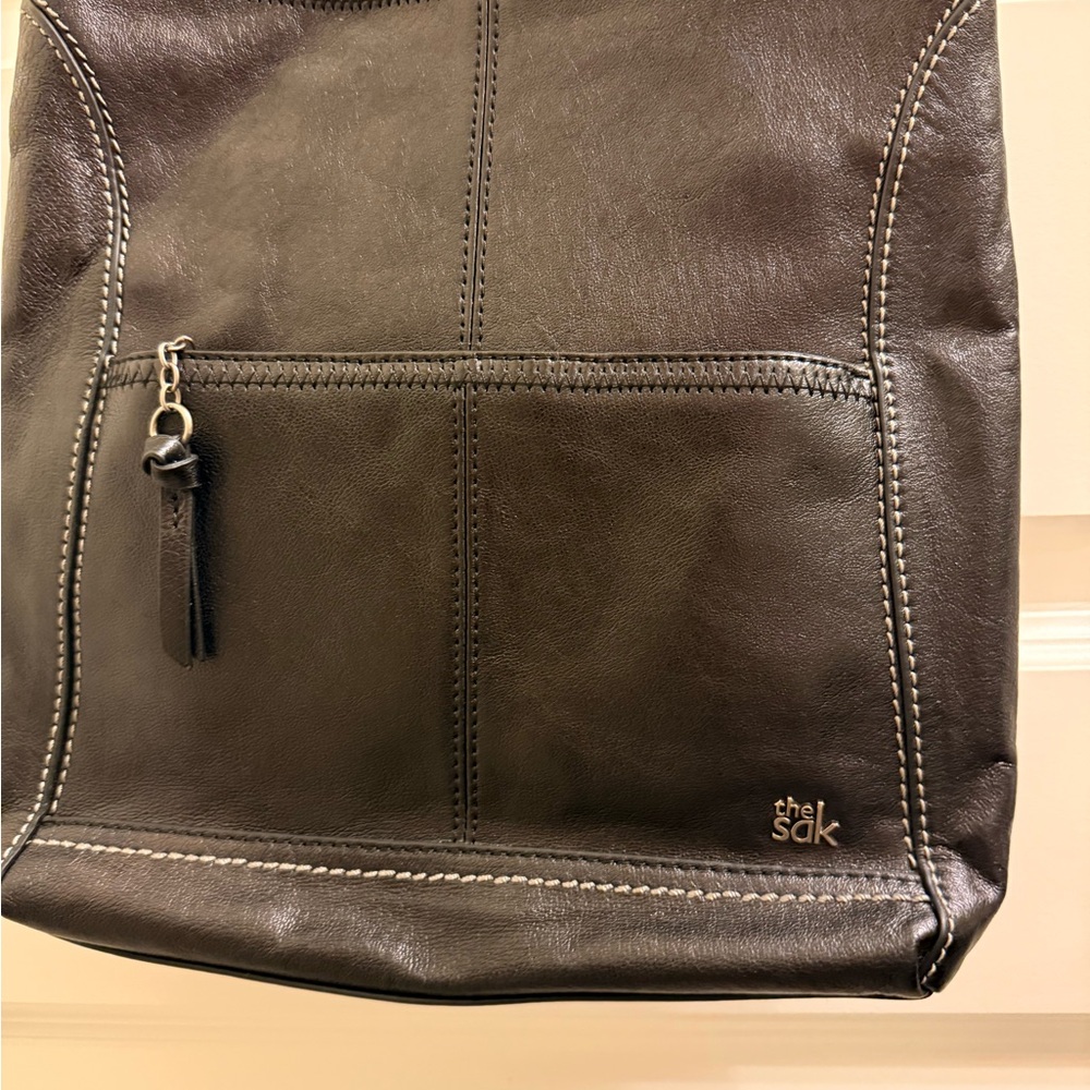 The Sak black Leather Backpack turquoise lining